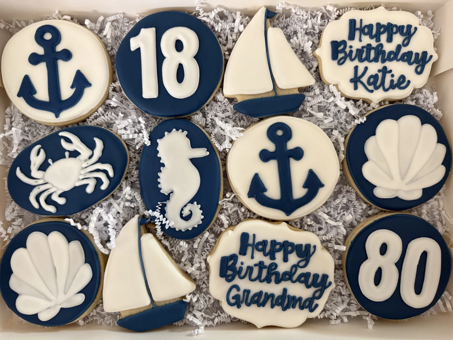 Navy nautical cookie collection with sailboats, anchors, and shells